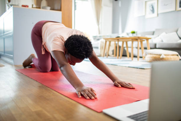 istock Young woman doing yoga at home 1484872904