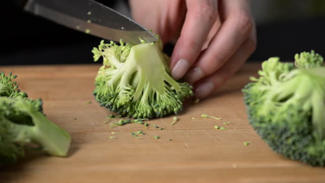 Preparing broccoli for cooking.
