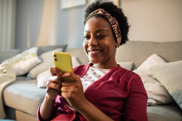 istock Young woman using a smart phone at home 1484874092