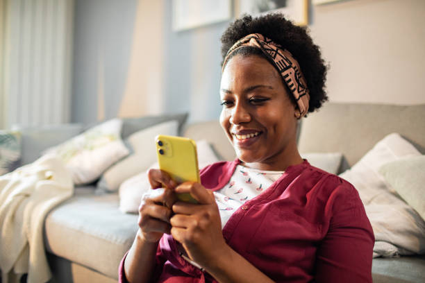 istock Young woman using a smart phone at home 1484874130