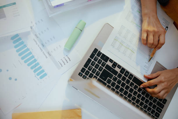istock business woman with documents and laptop working 1484874605