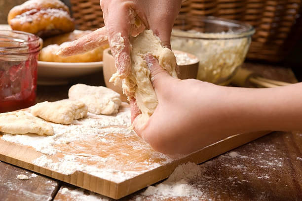 istock Detail of hands kneading dough 148487537