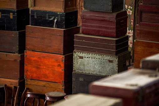 Pile of old vintage big wooden boxes stacked in a furniture store