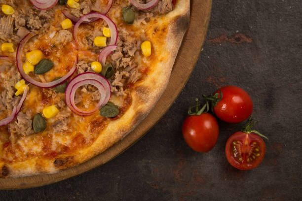 istock pizza with tuna fish and onion on the rusty background 1484877873