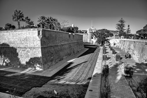 Mdina, Malta - April 22, 2022: Mdina ancient walls on a beautiful sunny day with tourists.