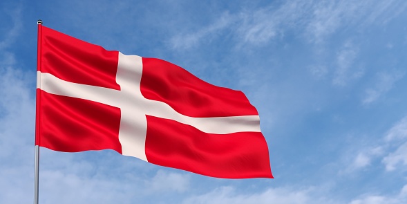 Denmark flag on flagpole on blue sky background. The Danish flag fluttering in the wind against a sky with white clouds. Place for text. 3d illustration.