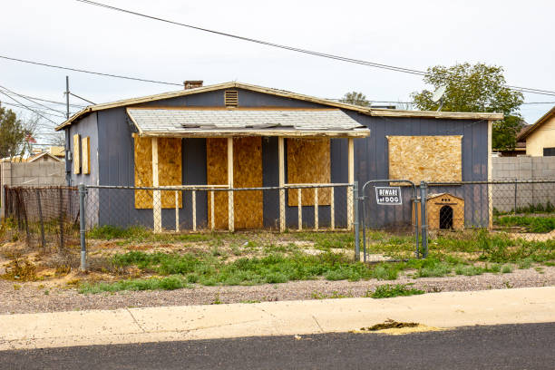 istock Abandoned Home With Boarded Up Windows And Doors 1484879652