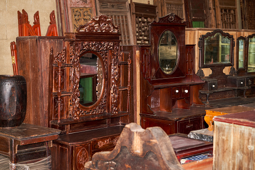 Close-up of furniture placed in a large mahogany furniture store