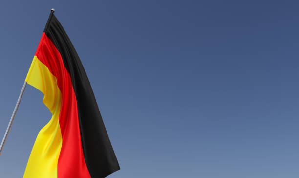 istock German flag on flagpole on blue background. Place for text. The flag is unfurling in wind. German, Berlin. Europe. 3D illustration. 1484880081