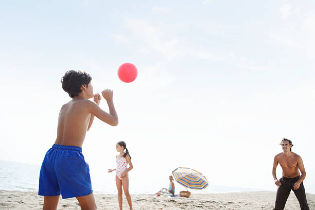 istock Father playing volleyball on beach with son and daughter (7-9) 148488072