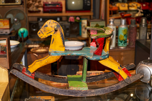 An old children's wooden horse toy in a thrift store