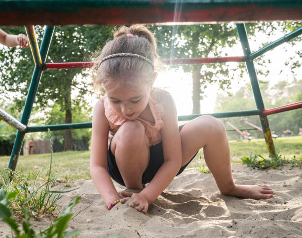 istock a little girl is playing in the sand 1484883295