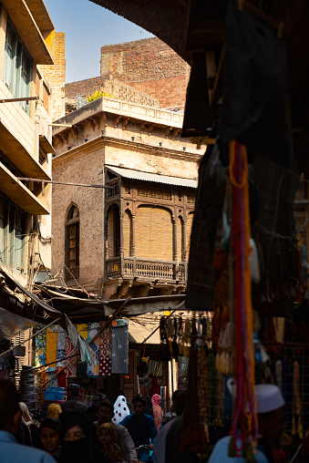 View of the Dehli gate market in Lahore, pakistan. The colourful street of the picturesque market is full of passers by and merchandise.