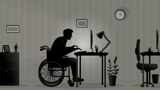 A young man with disabilities working alone in office