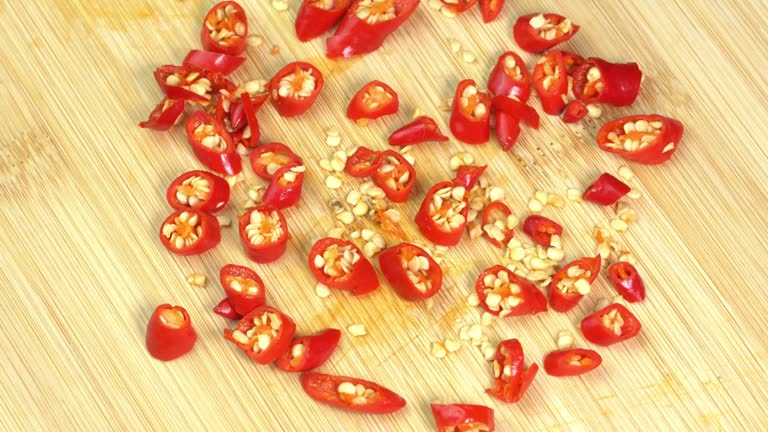 Knife Cut Chilli Pepper on Wooden Cutting Board. Hot Spicy Food concept