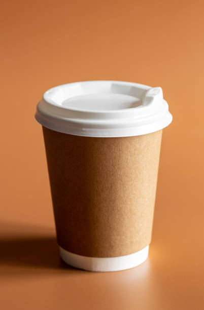 istock Eco-Friendly Craft Disposable Brown Cup on brown background Isolated. 1484887337