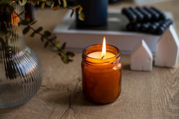 istock Handmade candle and bright burning white room interior decor 1484889613