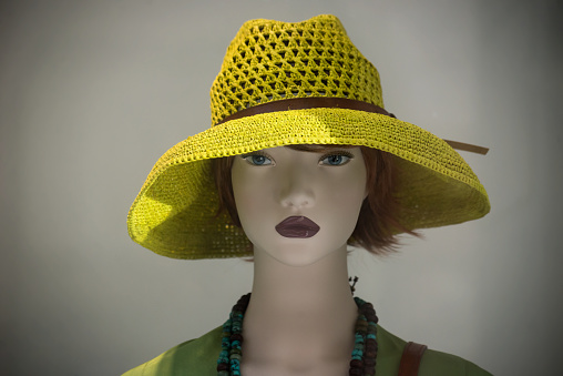 Closeup of summer hat on the head of mannequin in a fashion store showroom
