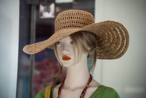 Closeup of summer hat on the head of mannequin in a fashion store showroom