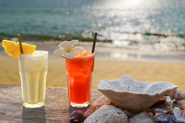 two drinks with a tropical beach in the background two drinks with a tropical beach in the background beach goa party stock pictures, royalty-free photos & images