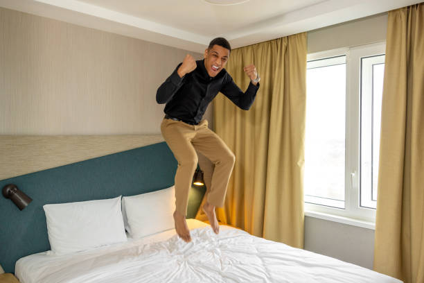 istock Young man in hotel room feeling enjoyed and excited 1484894325
