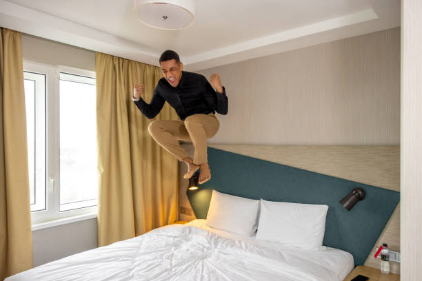istock Young man in hotel room feeling enjoyed and excited 1484894329