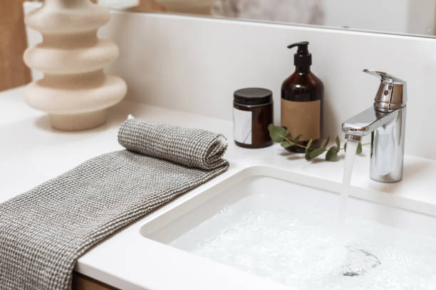 istock Washbasin from artificial stone filled clean water close to products for everyday use 1484896348
