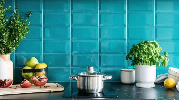istock stylish kitchen with cookware, electrical hob and blue tile on wall 1484897058