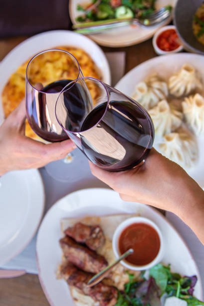 istock Georgian restaurant food on the table wine in hands. Selective focus. 1484898738