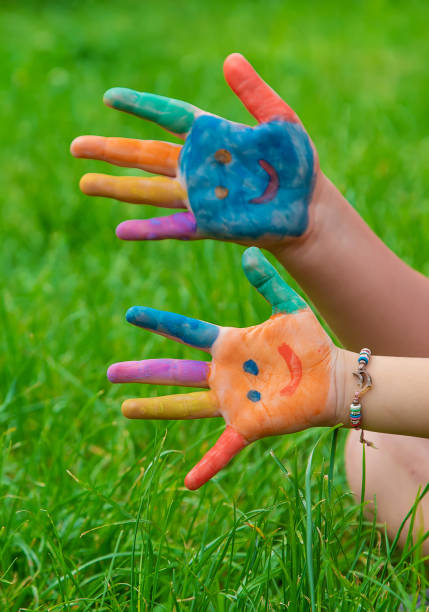 Smile on the hands of a child drawing. Selective focus. Kid.