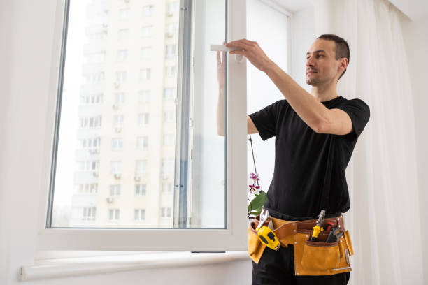 Young worker checking window after repair stock photo