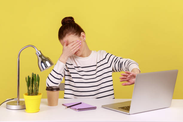 istock Confused woman closing eyes with hand, avoid watching shameful content on laptop. 1484902616
