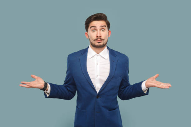 istock Uncertain confused handsome man with mustache standing with spread hands, don't know what happened. 1484903782