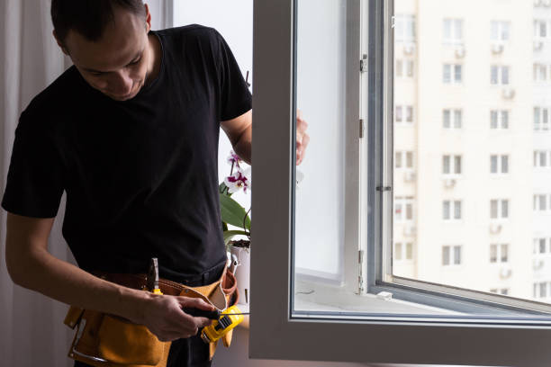 istock Master in gloves adjusting pvc windows with screwdriver closeup. Installation of plastic windows repair and maintenance concept 1484903837