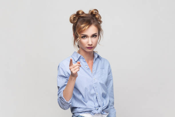 istock Woman raising index finger, looking with angry expression, warning you about danger. 1484904113