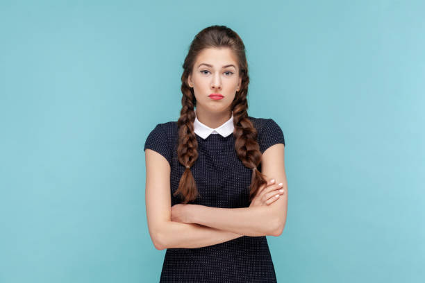 istock Upset attractive woman standing looking at camera, keeps hands folded, being in bad mood. 1484904401