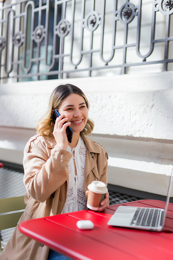 Woman using a laptop in a bar