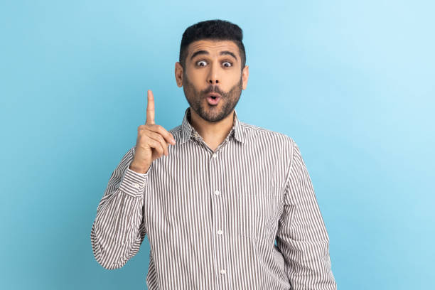 istock Bearded businessman pointing finger up and looking amazed about sudden genius idea, got solution. 1484904697
