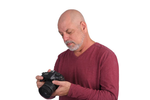 istock adult man bald beard elegant white with winter cold sweater with camera 1484906713