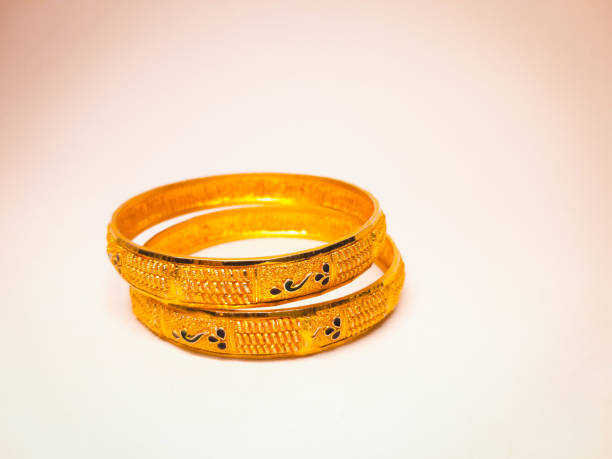 Gold bangles on white background Gold bangles on white background bangle stock pictures, royalty-free photos & images