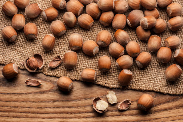 istock Heap crack hazel nut on sack on wooden table 1484909614