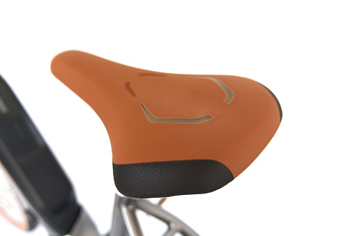 A closeup of a bicycle seat on a white background