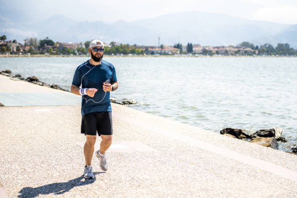 istock Seaside cardio. Jogging along the coastline 1484913256