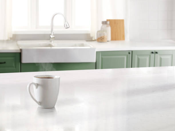 Coffee mug in a kitchen with a marble counter top and sink in the background
