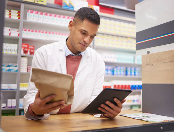 istock Pharmacy, tablet and pharmacist doing research on medication on the internet in a clinic. Healthcare, medical and male doctor or chemist reading information on prescription medicine on mobile device. 1484915501