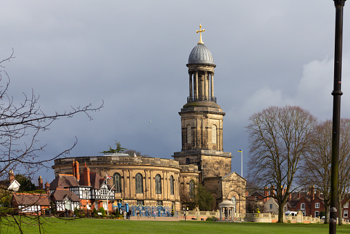 St Chads church in Shrewsbury viewed from the Quarry park on a stormy Spring day.