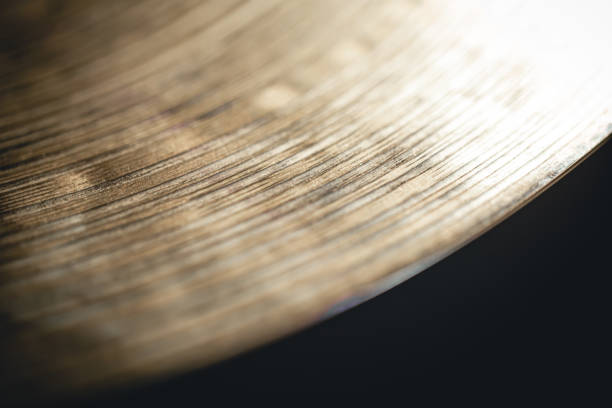 Close up of hi hat surface, drum cymbal close-up on a black background.