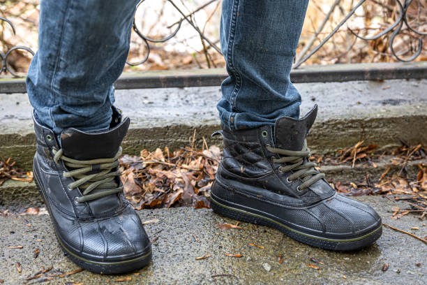 istock A man in boots in bad weather, close-up. 1484918105