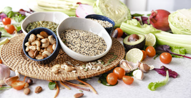 Close-up, a bowl of chia seeds and other healthy foods on the kitchen table. stock photo