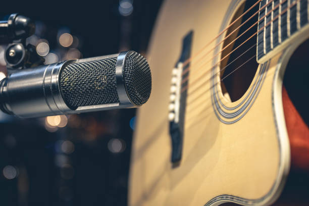 istock Acoustic guitar and microphone, recording in a music studio. 1484921014
